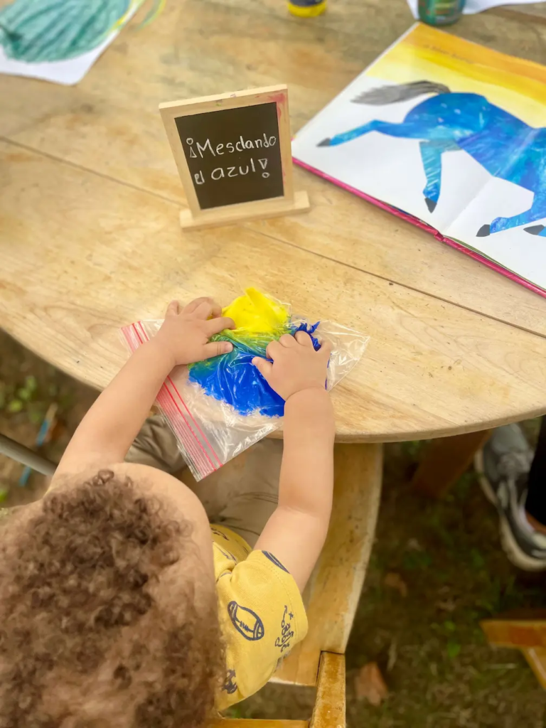Child painting with watercolors during art exploration